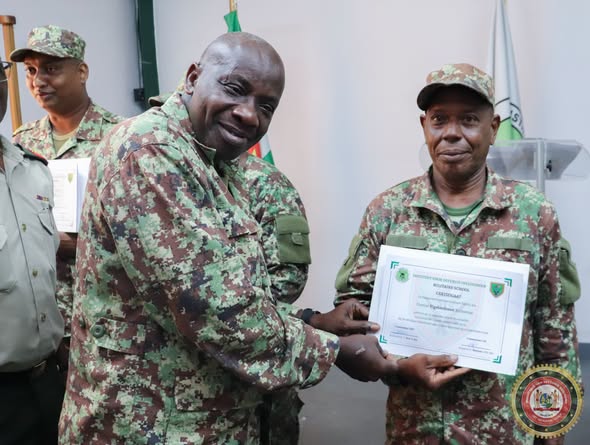 Uitreiking van een certificaat na de opleiding tot groepscommandant bij het Instituut voor Defensie Opleidingen.
